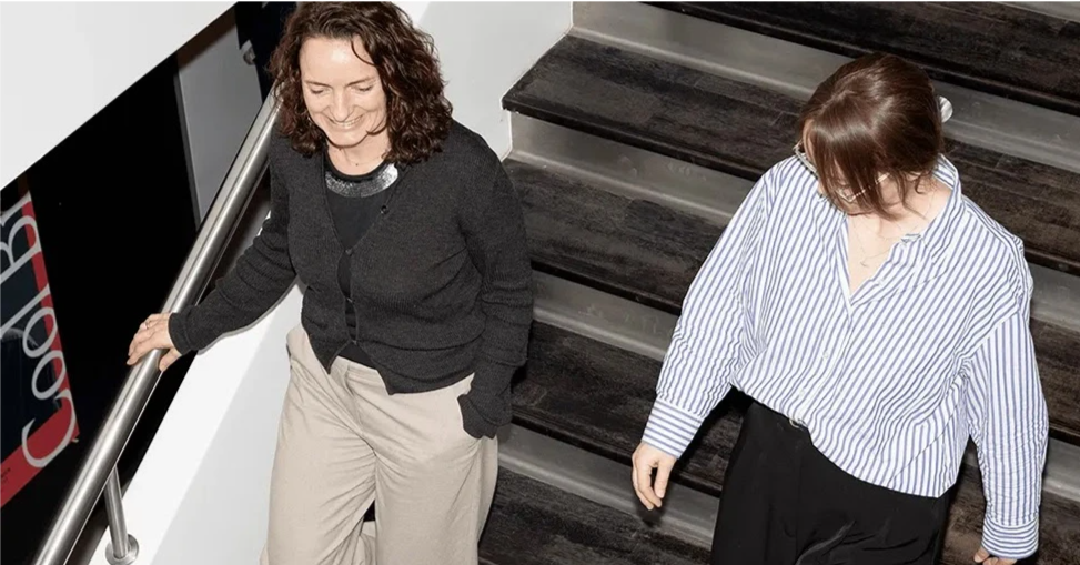 Rikke and Pernille walking down a staircase